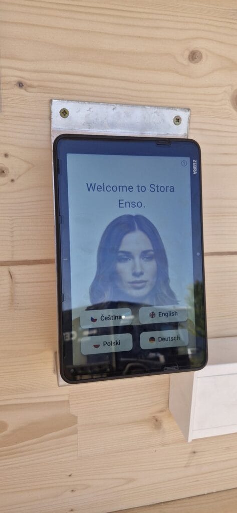 aReception kiosk with a Zebra ET401 tablet showing the multilingual welcome screen at Stora Enso Wood Products Ždírec